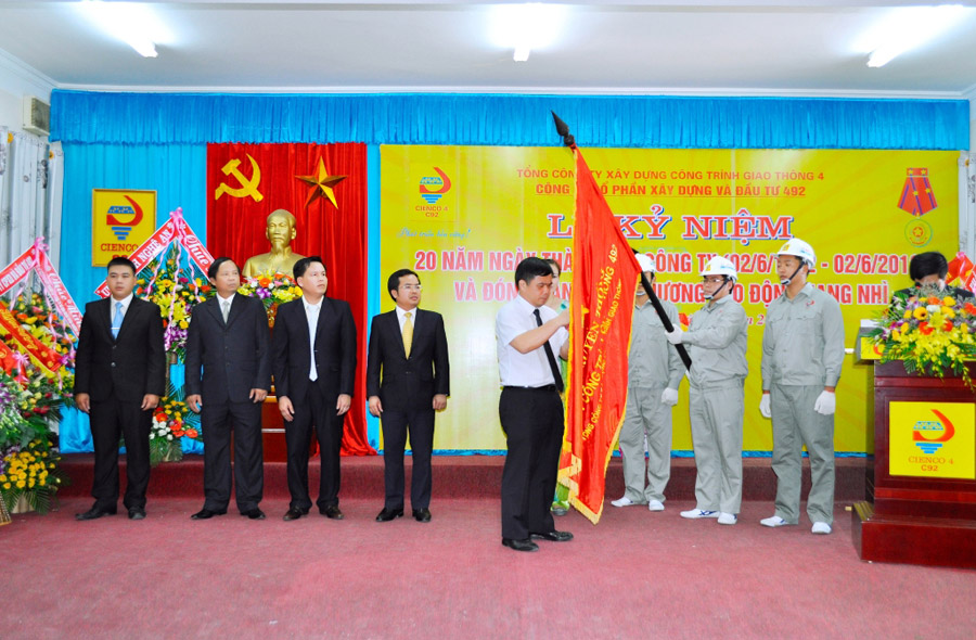 Đ/c Huỳnh Thanh Điền gắn Huân chương Lao động hạng Nhì năm 2012 lên lá cờ truyền thống của công ty